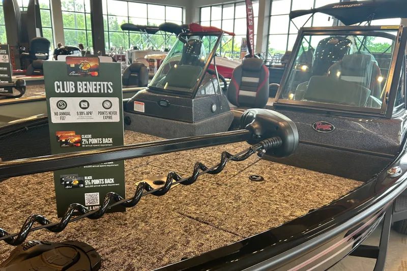 Slide: The Image of 2026 Ranger VS1782SC Angler boat displayed indoors with club benefits sign. - 1