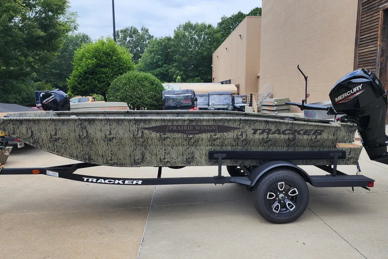 The Image of 2026 Tracker Grizzly 1650 T Prairie Wings Edition boat on trailer, outdoors. - 0
