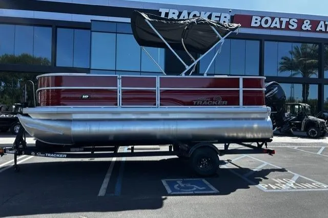 The Image of 2026 Sun Tracker Party Barge 18 DLX pontoon boat displayed outside dealership. - 0