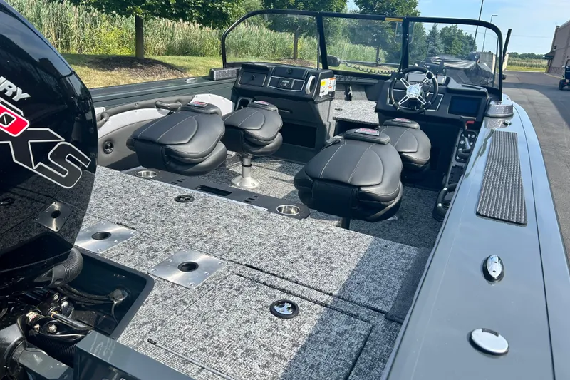 Slide: The Image of 2026 Ranger VX1788 WT boat interior with seating and Mercury engine, parked outdoors. - 4