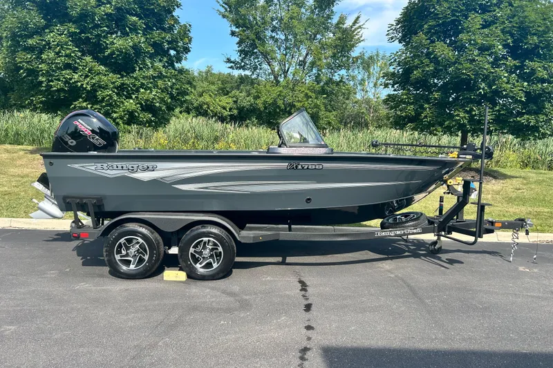 Slide: The Image of 2026 Ranger VX1788 WT boat on trailer, parked outdoors with lush greenery background. - 1
