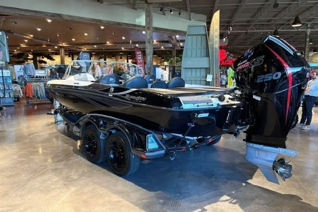 Slide: The Image of 2026 Ranger 212LS boat with powerful engine on display in showroom. - 3