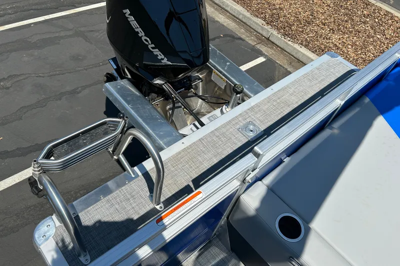 Slide: The Image of 2026 Sun Tracker Party Barge 22 RF XP3 with Mercury outboard motor, rear deck view. - 21