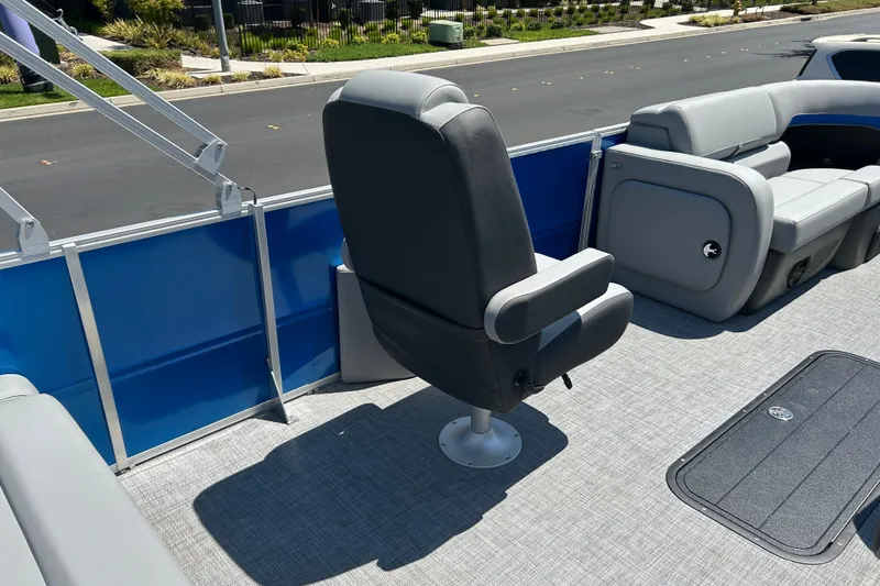 Slide: The Image of 2026 Sun Tracker Party Barge 22 RF XP3 interior with gray seating and blue paneling. - 22