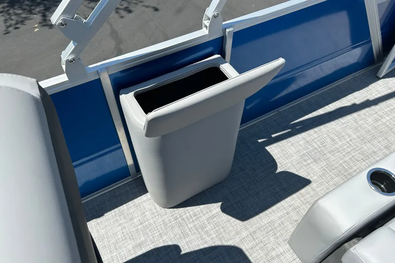 Slide: The Image of 2026 Sun Tracker Party Barge 22 RF XP3 interior with built-in trash bin and seating. - 17