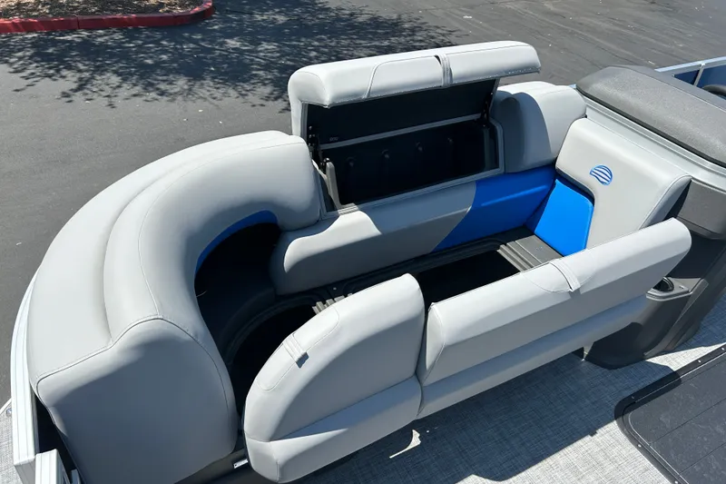 Slide: The Image of 2026 Sun Tracker Party Barge 22 RF XP3 seating area with storage compartments open. - 13