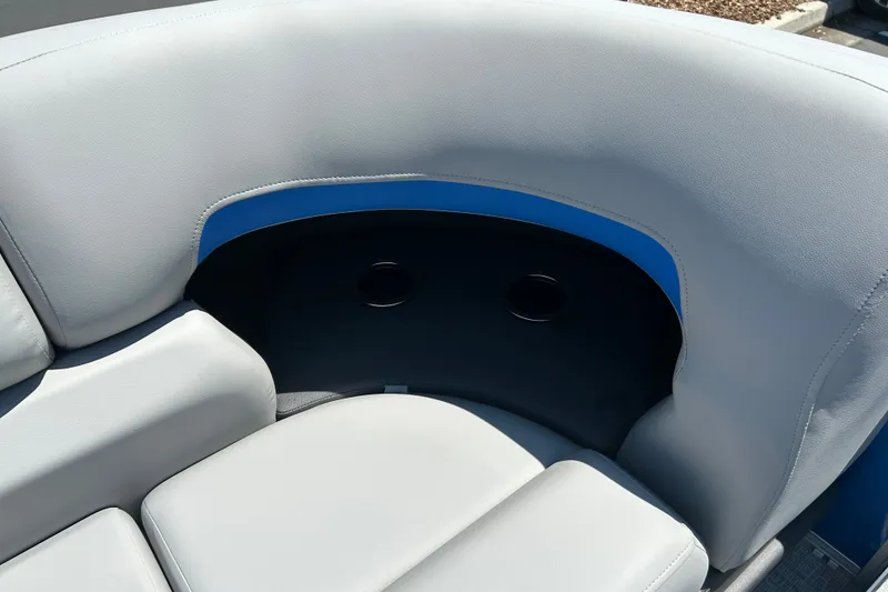 Slide: The Image of 2026 Sun Tracker Party Barge 22 RF XP3 seating with cup holders, featuring gray and blue upholstery. - 16