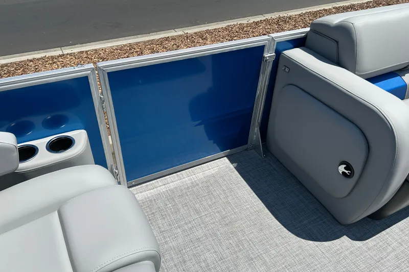 Slide: The Image of 2026 Sun Tracker Party Barge 22 RF XP3 interior with gray seating and blue paneling. - 25