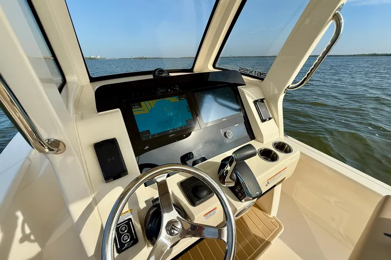 Slide: The Image of Helm of 2026 Scout 261 XSS boat with navigation display and steering wheel. - 28