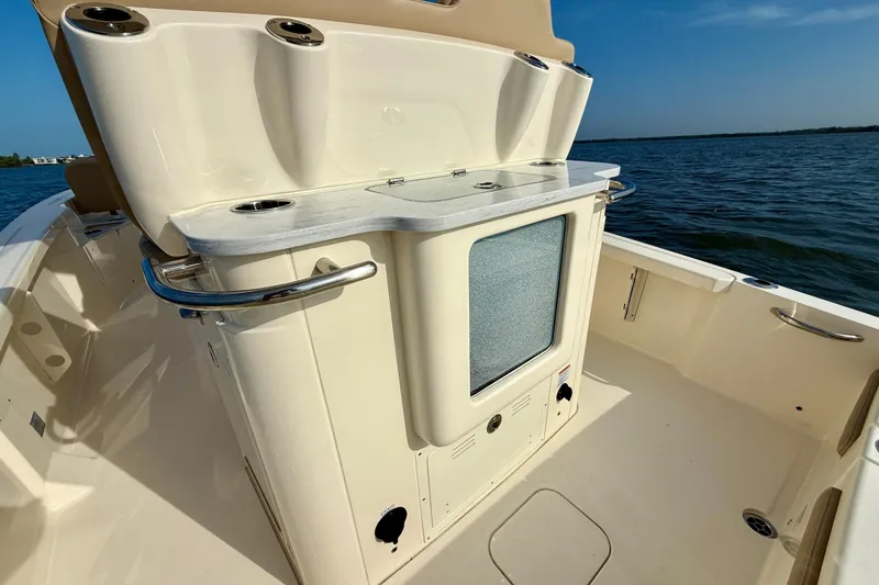 Slide: The Image of 2026 Scout 261 XSS boat interior with console and ocean view. - 26