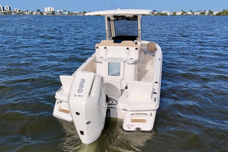 Slide: The Image of 2026 Scout 261 XSS boat with Mercury V10 engine on open water. - 16
