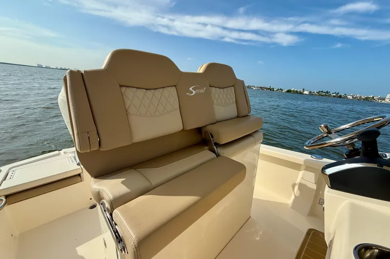 Slide: The Image of Luxurious seating on 2026 Scout 261 XSS boat with scenic water view. - 27