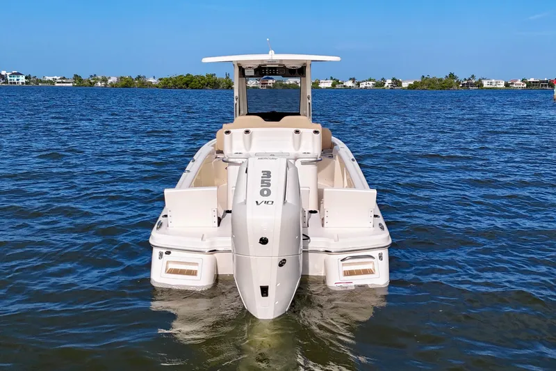 Slide: The Image of 2026 Scout 261 XSS boat with powerful Mercury V10 engine on open water. - 17