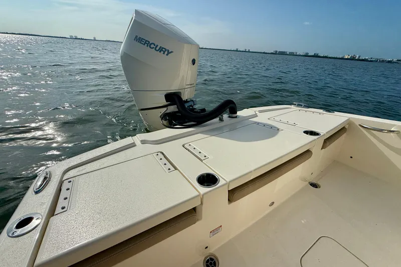 Slide: The Image of 2026 Scout 261 XSS boat with Mercury engine on calm water. - 23