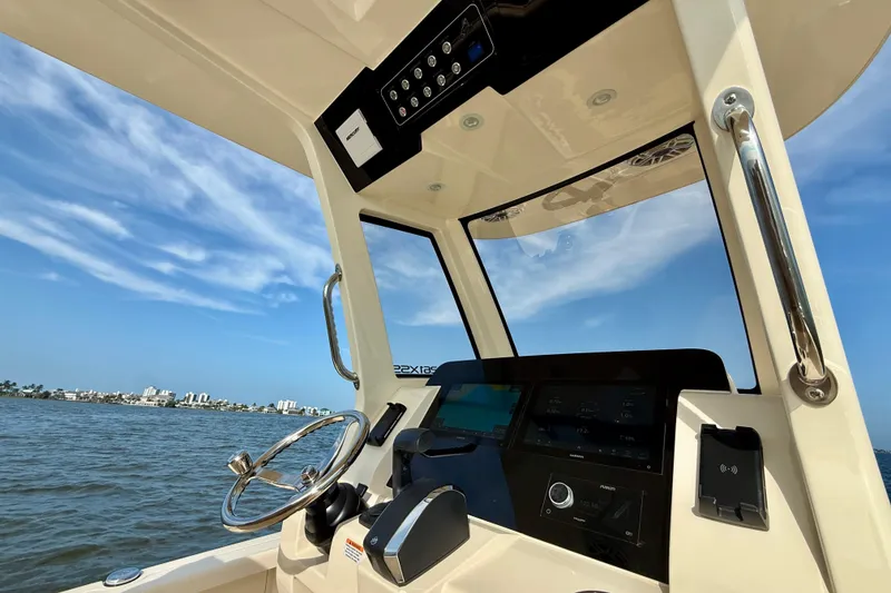 Slide: The Image of Interior view of 2026 Scout 261 XSS boat cockpit with steering wheel and control panel. - 30