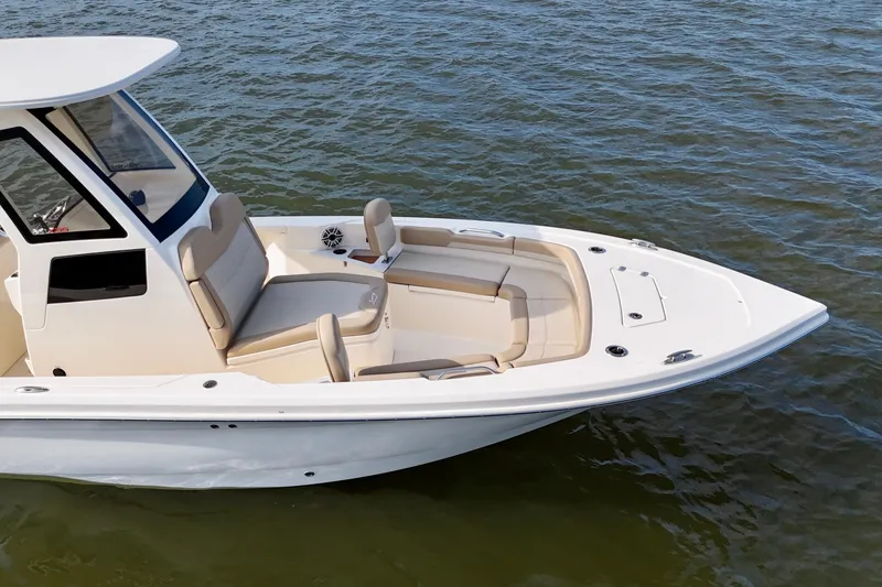 Slide: The Image of 2026 Scout 261 XSS boat with sleek design and comfortable seating on calm water. - 21