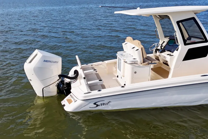 Slide: The Image of 2026 Scout 261 XSS boat with Mercury engine on calm water. - 22