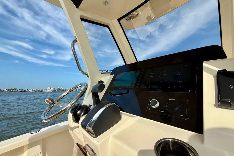 Slide: The Image of Interior view of 2026 Scout 261 XSS boat cockpit with steering wheel and navigation screens. - 29