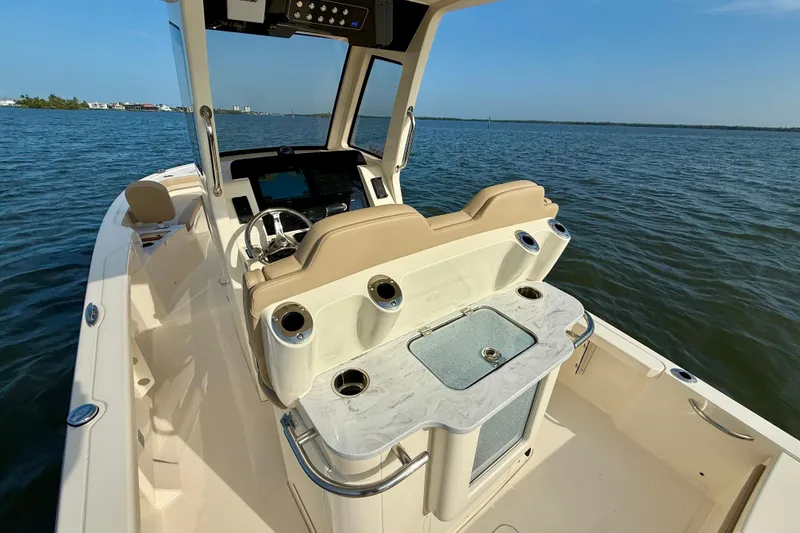 Slide: The Image of 2026 Scout 261 XSS boat interior with helm, seating, and ocean view. - 25