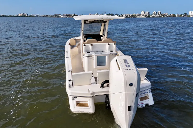 Slide: The Image of 2026 Scout 261 XSS boat on water, featuring a powerful outboard motor. - 19