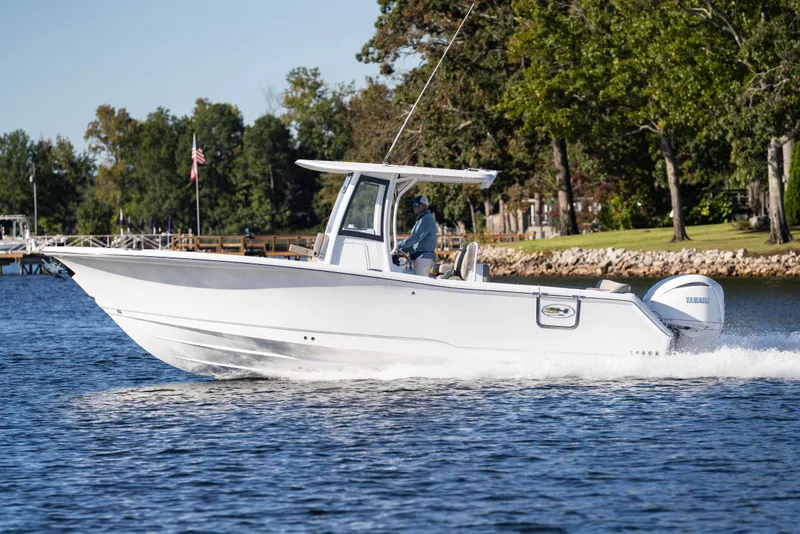 Slide: The Image of 2026 Sea Hunt Ultra 275 Coffin Box boat cruising on a lake. - 25