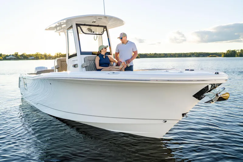Slide: The Image of 2026 Sea Hunt Ultra 275 Coffin Box boat on calm water with two people onboard. - 51