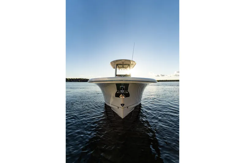 Slide: The Image of Front view of 2026 Sea Hunt Ultra 275 Coffin Box boat on water at sunset. - 53