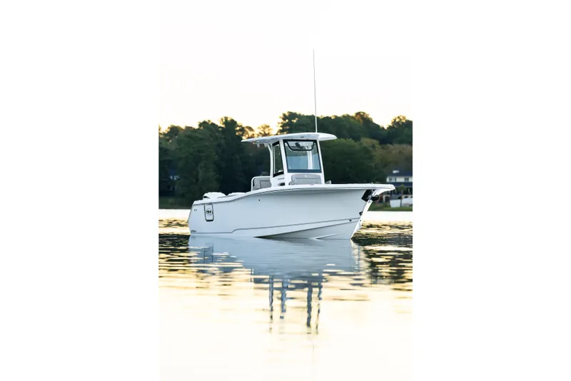 Slide: The Image of 2026 Sea Hunt Ultra 275 Coffin Box boat on calm water at sunset. - 45