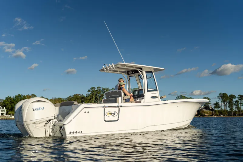 Slide: The Image of 2026 Sea Hunt Ultra 275 Coffin Box boat on water, clear sky background. - 62