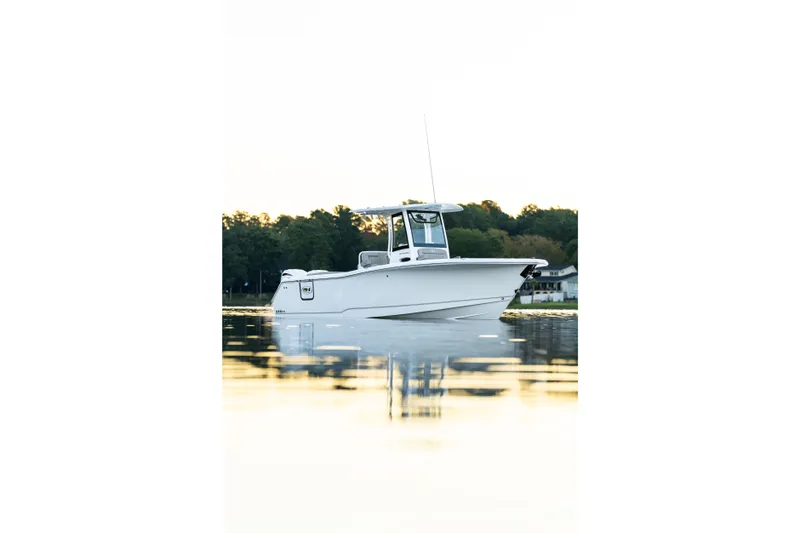Slide: The Image of 2026 Sea Hunt Ultra 275 Coffin Box boat on calm water at sunset. - 43