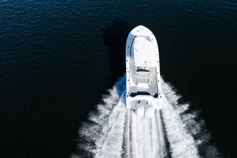 Slide: The Image of Aerial view of 2026 Sea Hunt Ultra 275 Coffin Box boat cruising on water. - 29