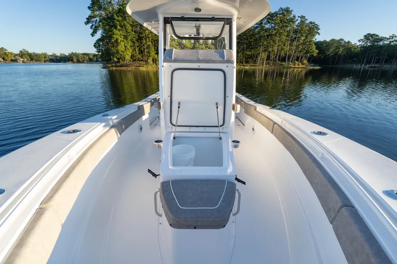 Slide: The Image of 2026 Sea Hunt Ultra 275 Coffin Box boat on serene lake. - 31