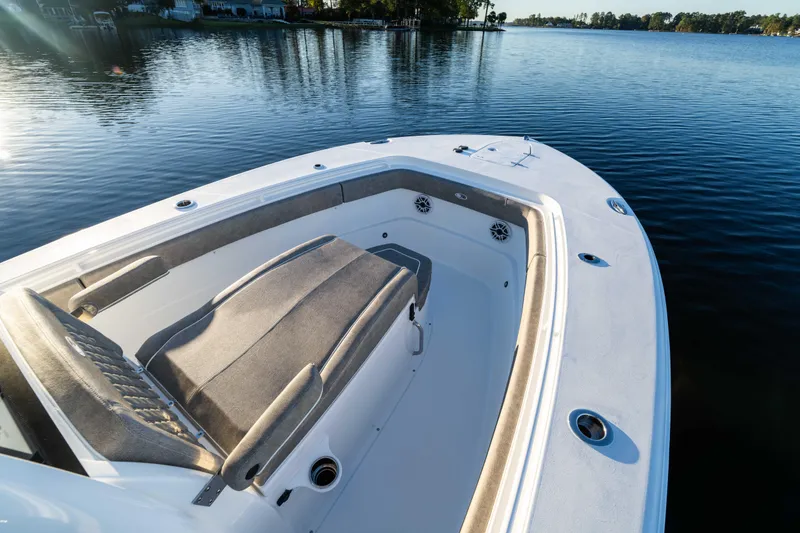 Slide: The Image of 2026 Sea Hunt Ultra 275 Coffin Box boat on calm water, showcasing spacious seating. - 27