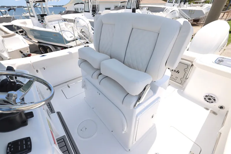 Slide: The Image of 2027 Sea Hunt Gamefish 25 boat interior with plush seating and steering wheel. - 17