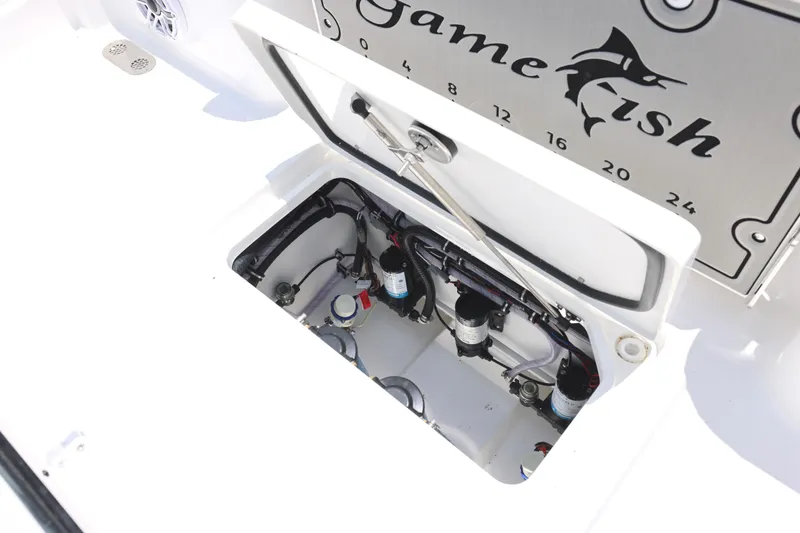 Slide: The Image of 2027 Sea Hunt Gamefish 25 boat compartment with open hatch, showcasing internal components. - 14