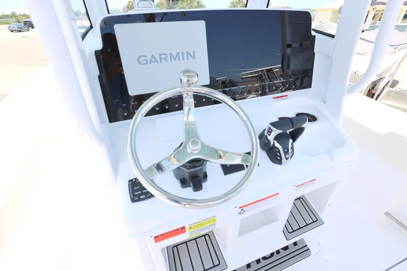 Slide: The Image of 2027 Sea Hunt Gamefish 25 helm with Garmin display and steering wheel. - 6