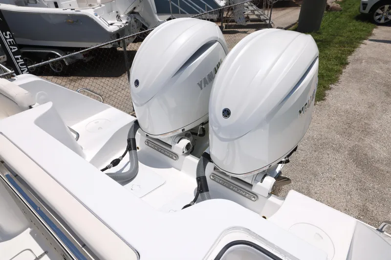 Slide: The Image of 2027 Sea Hunt Gamefish 25 with dual Yamaha outboard engines, parked on a sunny day. - 22