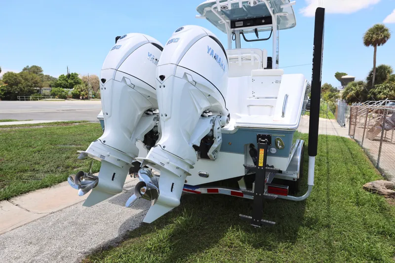 Slide: The Image of 2027 Sea Hunt Gamefish 25 boat with dual Yamaha outboard motors on a trailer. - 11