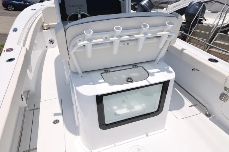 Slide: The Image of 2027 Sea Hunt Gamefish 25 boat interior with rod holders and storage compartment. - 7