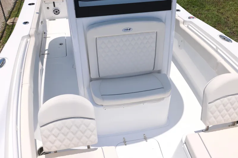 Slide: The Image of 2027 Sea Hunt Gamefish 25 boat interior with white cushioned seating and sleek design. - 25