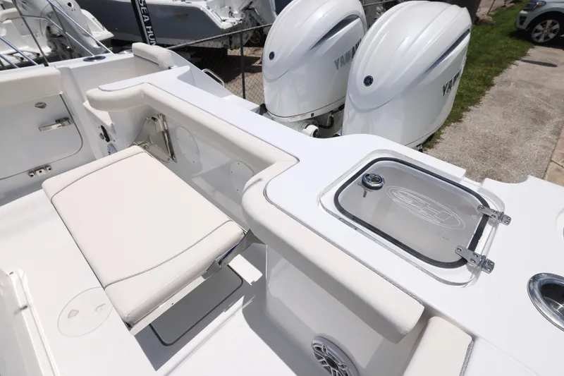 Slide: The Image of 2027 Sea Hunt Gamefish 25 boat interior with seating and dual Yamaha engines. - 23