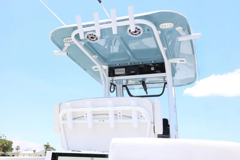Slide: The Image of 2027 Sea Hunt Gamefish 25 boat with T-top and rod holders against blue sky. - 2