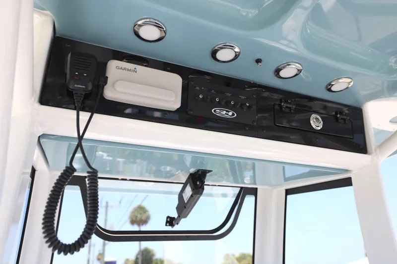 Slide: The Image of 2027 Sea Hunt Gamefish 25 boat console with Garmin electronics and overhead lighting. - 10