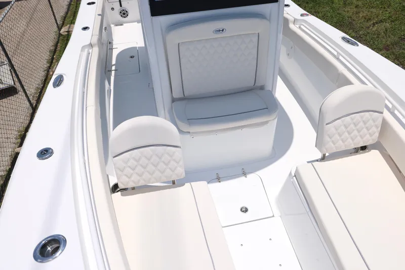 Slide: The Image of 2027 Sea Hunt Gamefish 25 boat interior with white cushioned seating and sleek design. - 24