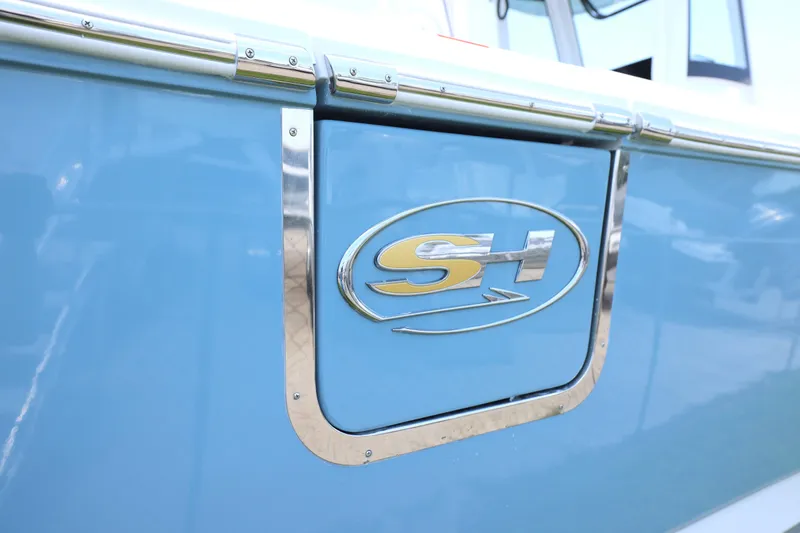 Slide: The Image of 2027 Sea Hunt Gamefish 25 boat with SH logo on blue hull. - 27