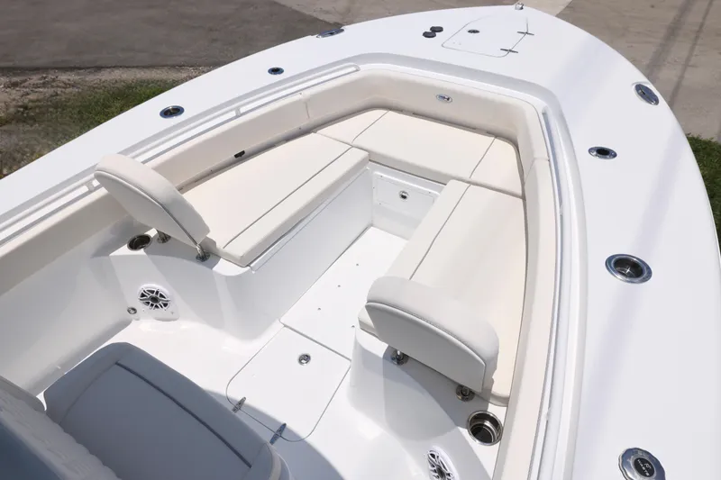 Slide: The Image of 2027 Sea Hunt Gamefish 25 boat interior with white cushioned seating. - 18