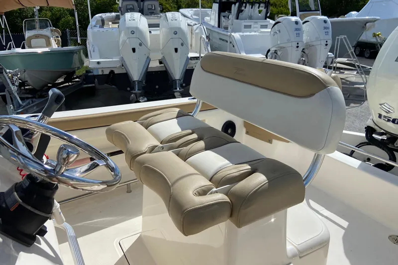 Slide: The Image of 2016 Pioneer 197 Sportfish boat interior with steering wheel and cushioned seating. - 22