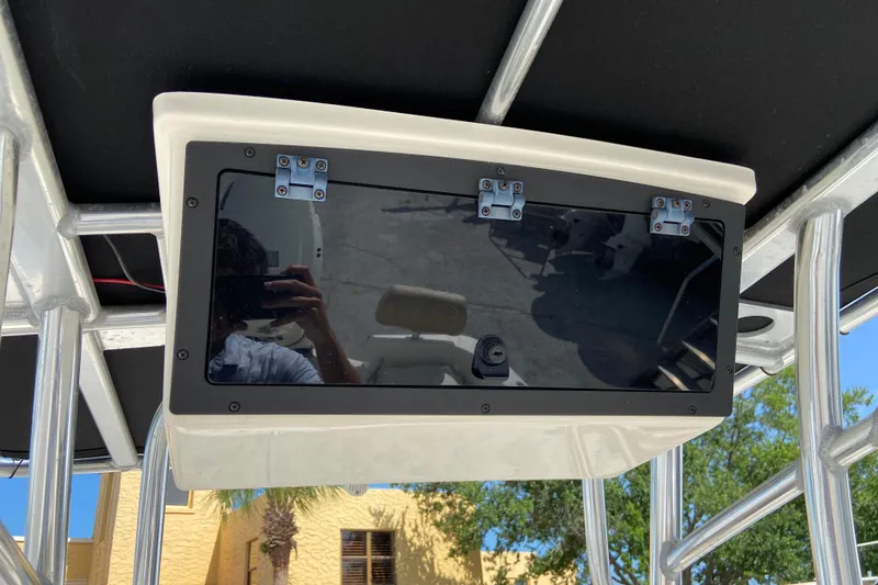 Slide: The Image of 2016 Pioneer 197 Sportfish boat console with reflective glass and metal frame. - 24