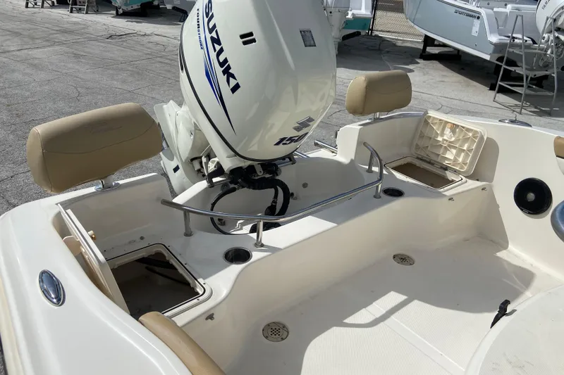 Slide: The Image of 2016 Pioneer 197 Sportfish boat with Suzuki 150 outboard motor, featuring open storage compartments. - 15