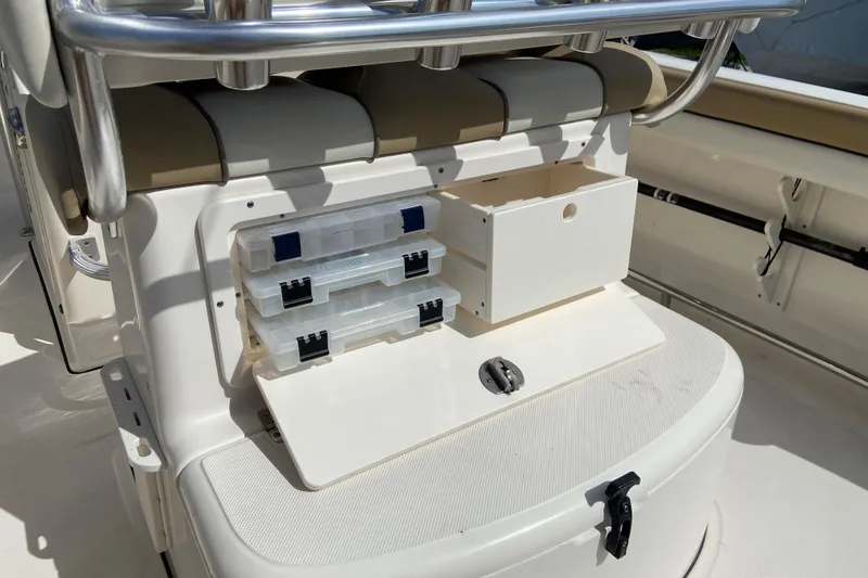 Slide: The Image of 2016 Pioneer 197 Sportfish boat storage area with tackle boxes and seating. - 18
